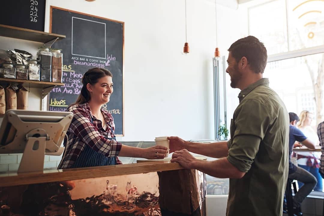 Barista giving a customer's cup of coffee